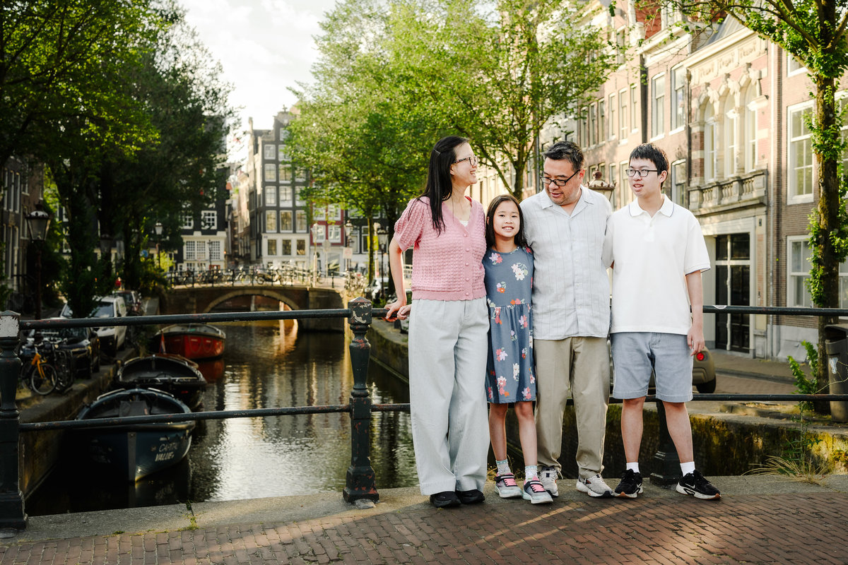 Parents embracing their children during a vacation photo session.