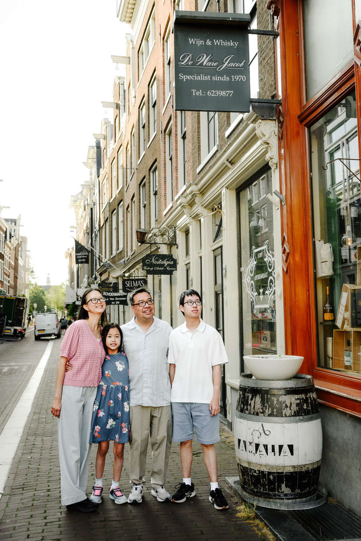 Family enjoying a quiet morning walk through Amsterdam's Canal Belt.