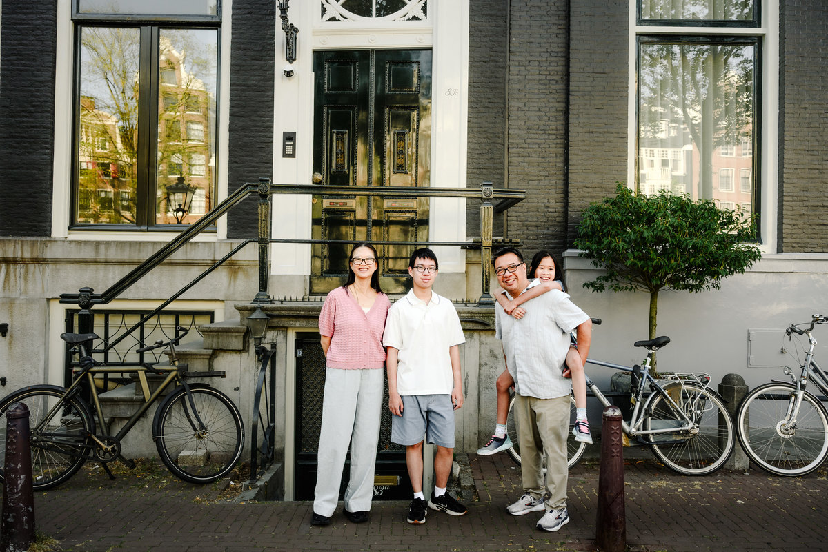 Family exploring Amsterdam's canals together.