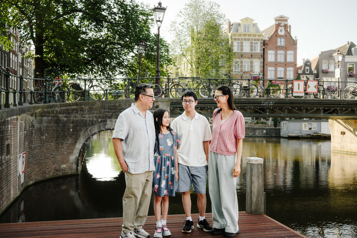 Family enjoying a quiet morning walk through Amsterdam's Canal Belt.