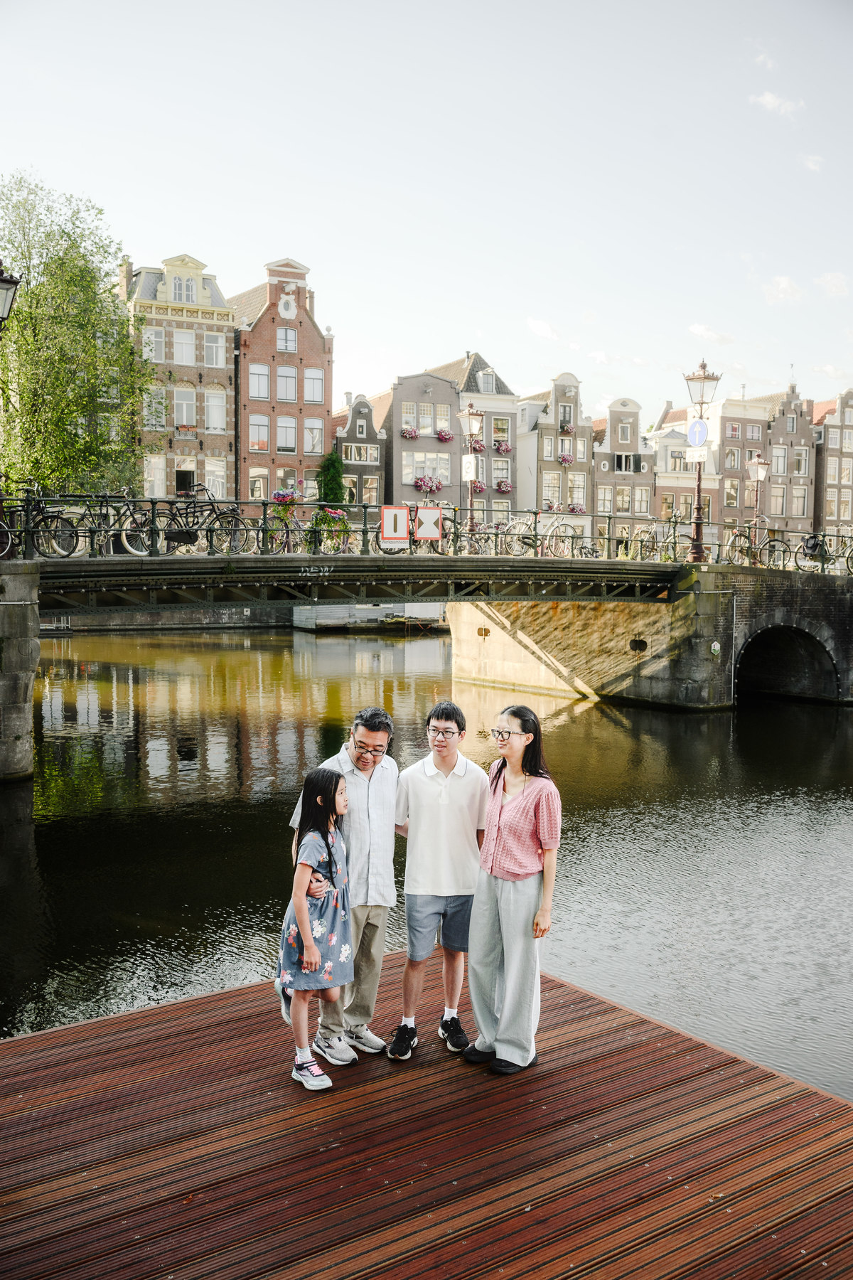 Family enjoying a quiet morning walk through Amsterdam's Canal Belt.
