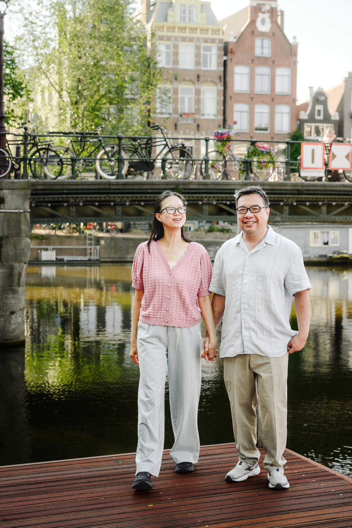 Parents sharing a quiet moment beside Amsterdam's historic canals.
