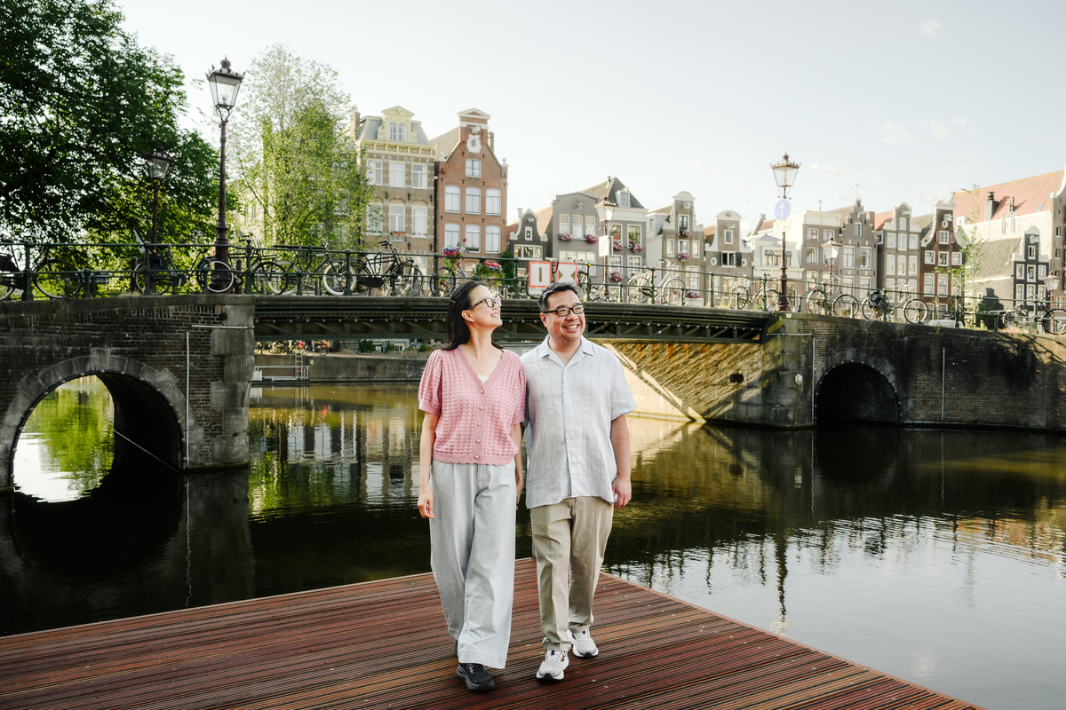Couple enjoying a peaceful walk through Amsterdam's Canal Belt.