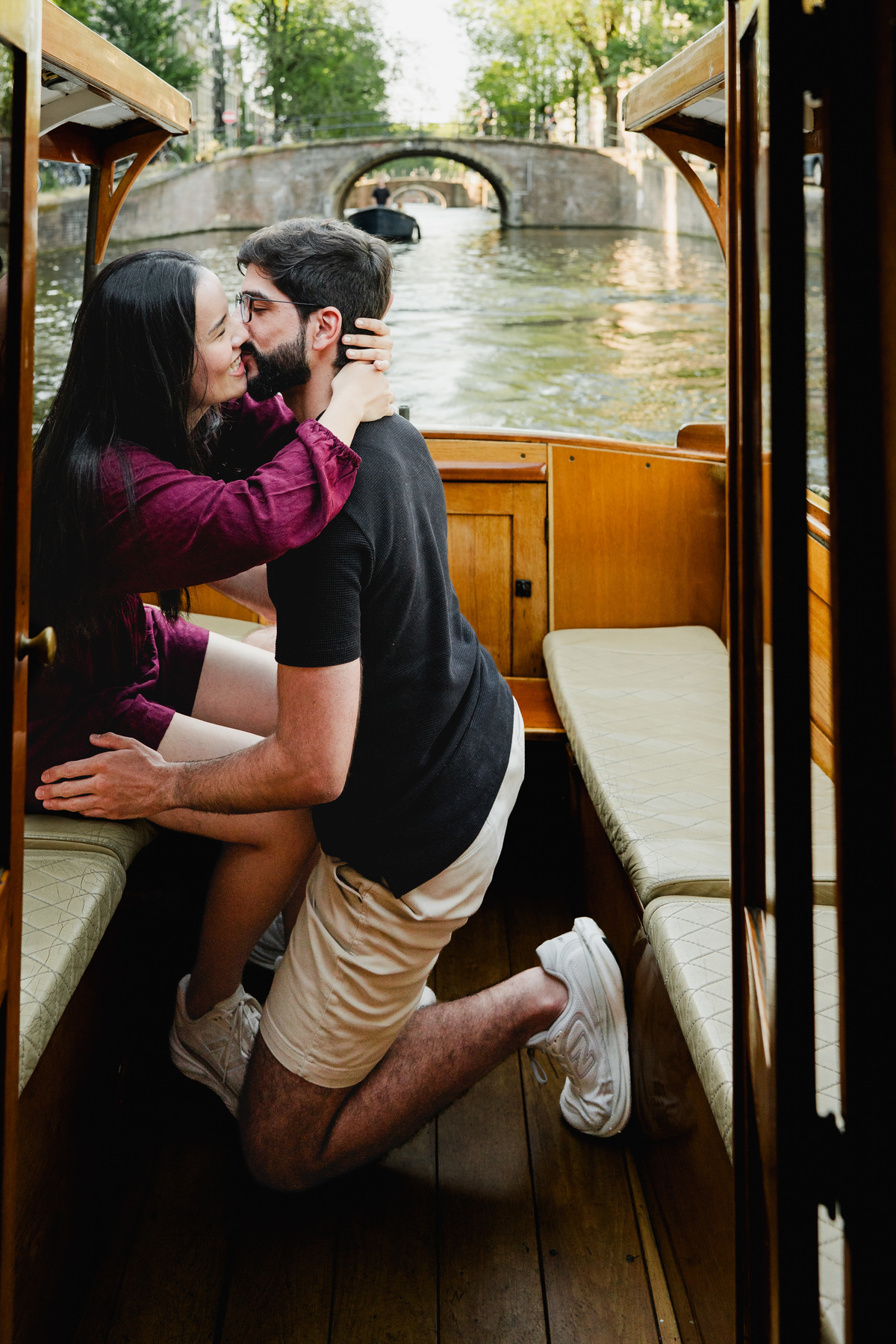 Emotional proposal moment during a private canal cruise in Amsterdam.