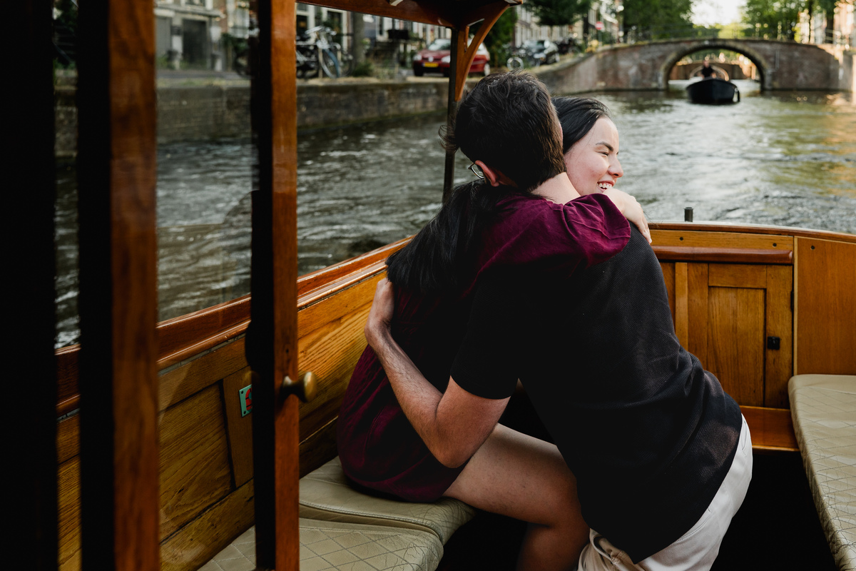 Emotional proposal moment during a private canal cruise in Amsterdam.