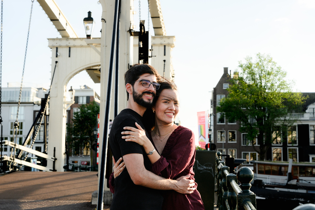 Couple walking through Amsterdam after their canal boat proposal.