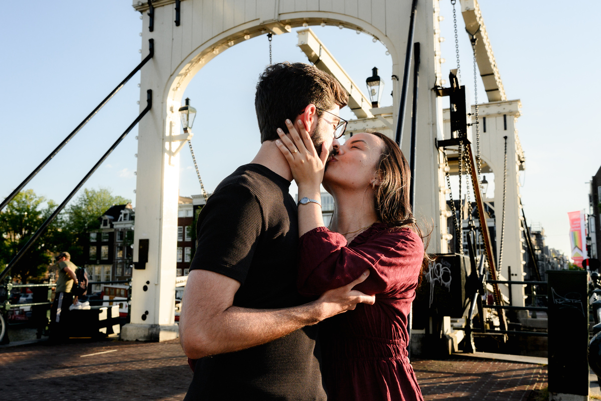 Romantic portrait of an engaged couplet the Skinny Bridge after their engagement proposal on a boat