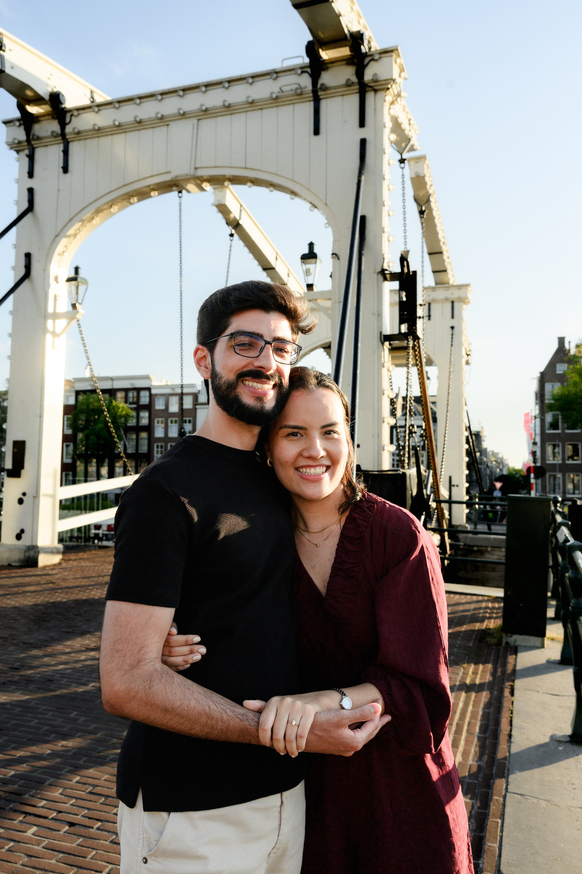 Romantic portrait of an engaged couplet the Skinny Bridge after their engagement proposal on a boat