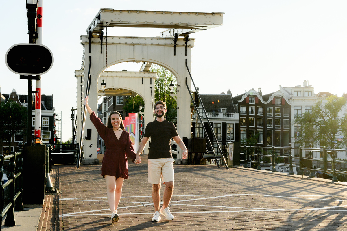 Couple walking through Amsterdam after their canal boat proposal.