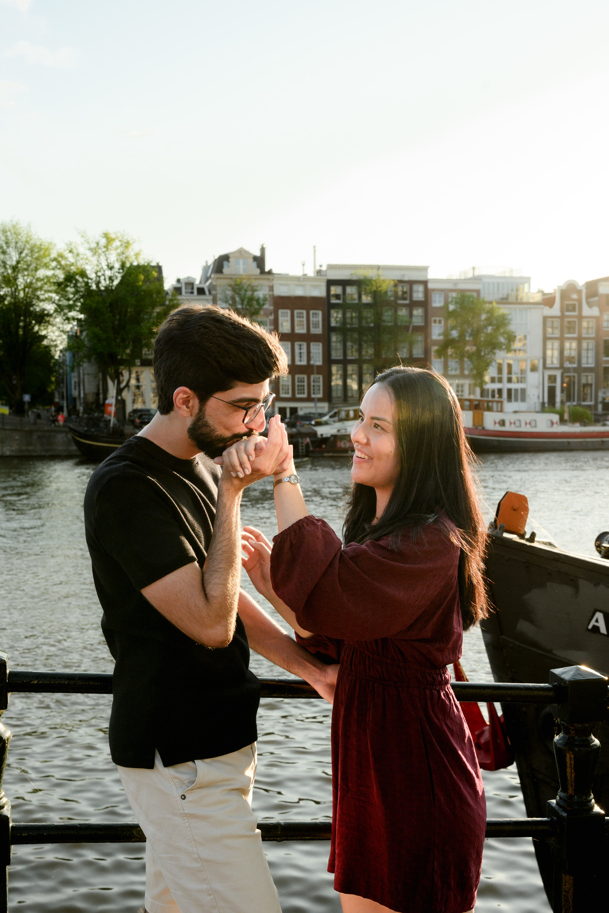 Romantic portrait of an engaged couplet the Skinny Bridge after their engagement proposal on a boat