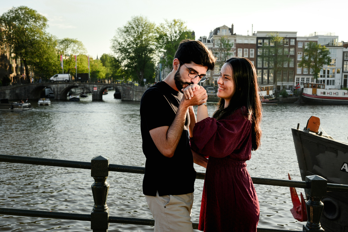 Romantic portrait of an engaged couplet the Skinny Bridge after their engagement proposal on a boat