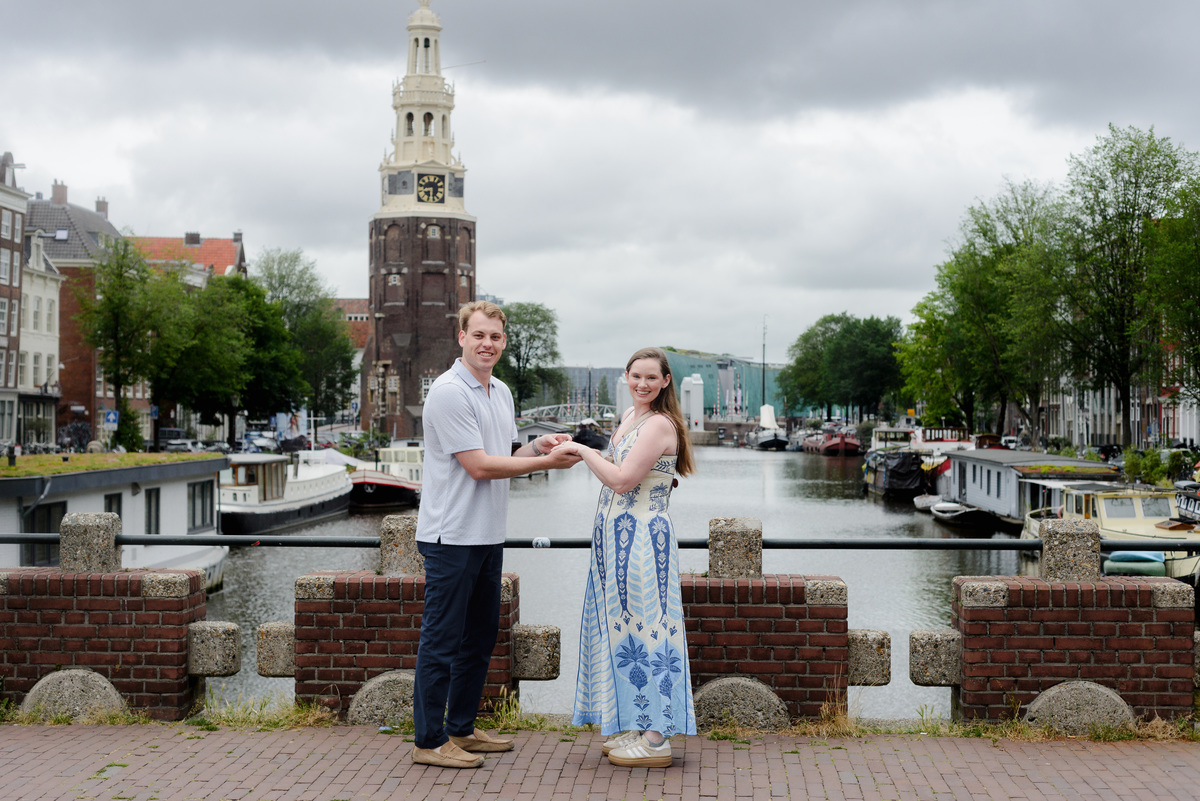 Woman reacting to a surprise proposal beside an Amsterdam canal