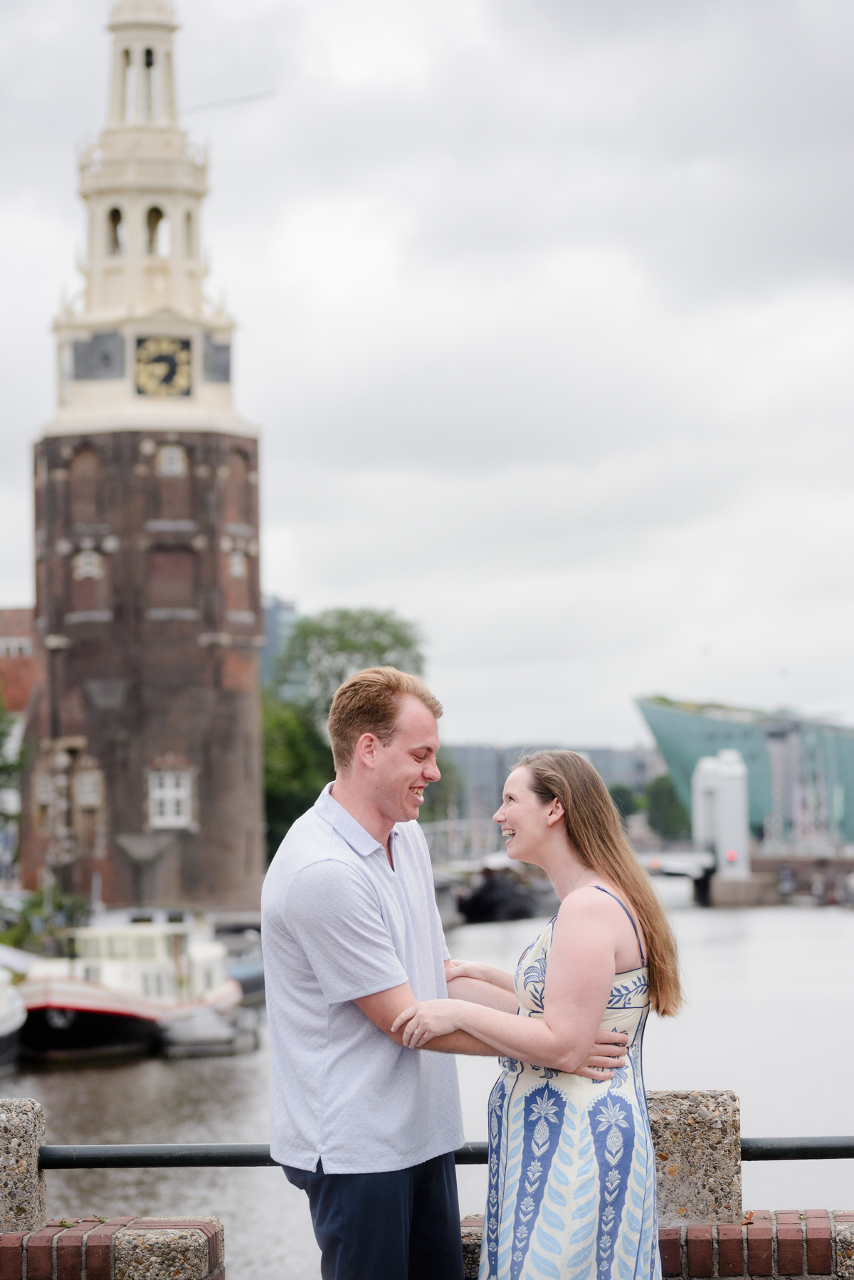 Newly engaged couple beside Oudeschans in Amsterdam