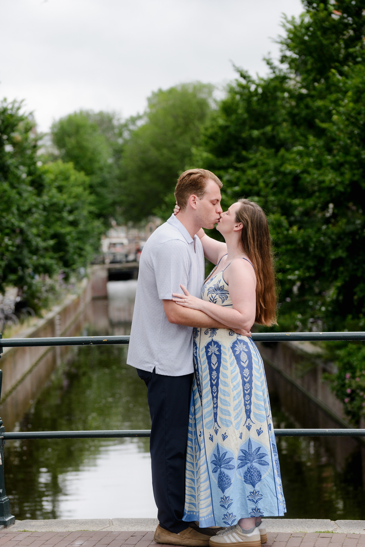 Newly engaged couple beside Oudeschans in Amsterdam