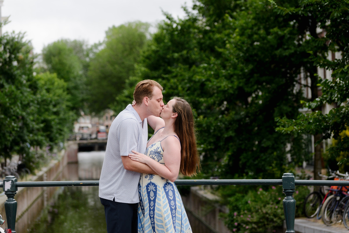 Newly engaged couple beside Oudeschans in Amsterdam