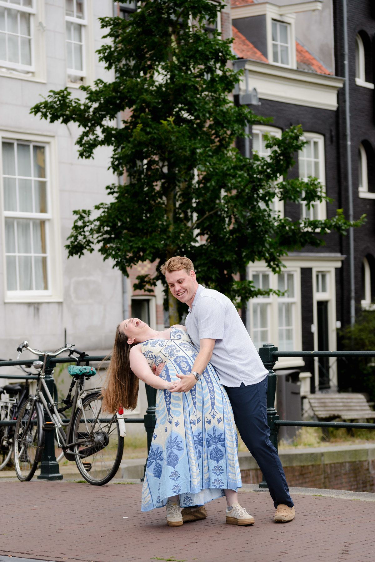 Newly engaged couple beside Oudeschans in Amsterdam