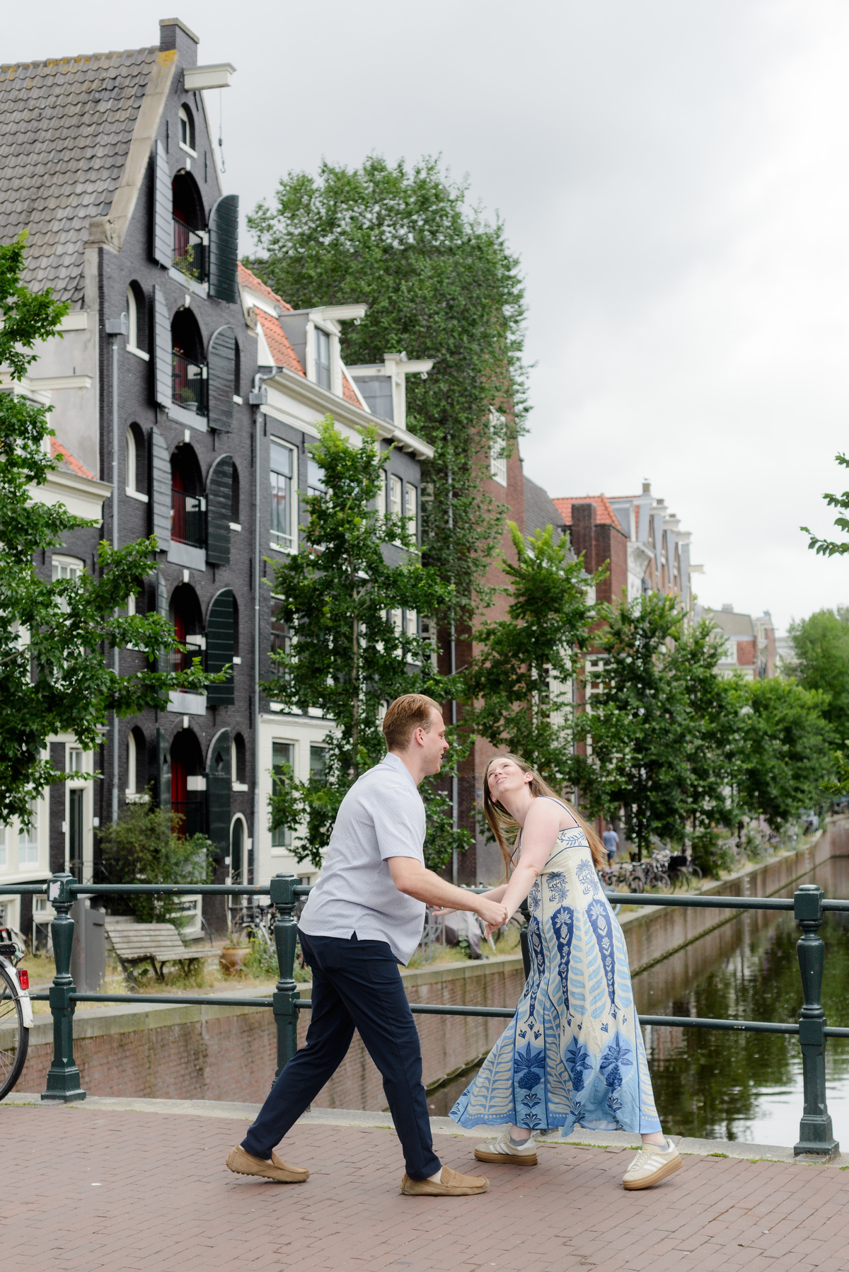 Couple celebrating their engagement beside the canals in Amsterdam