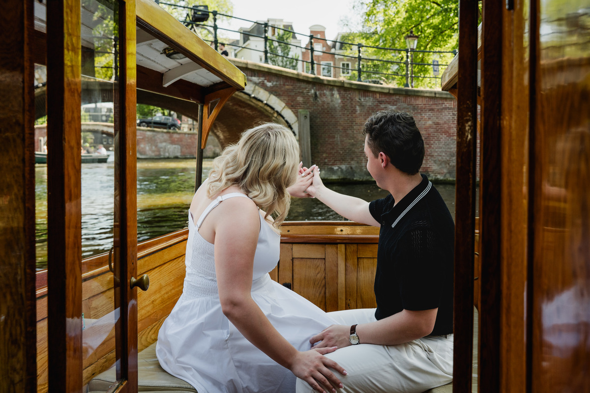 Engagement ring moment aboard a historic Amsterdam canal boat