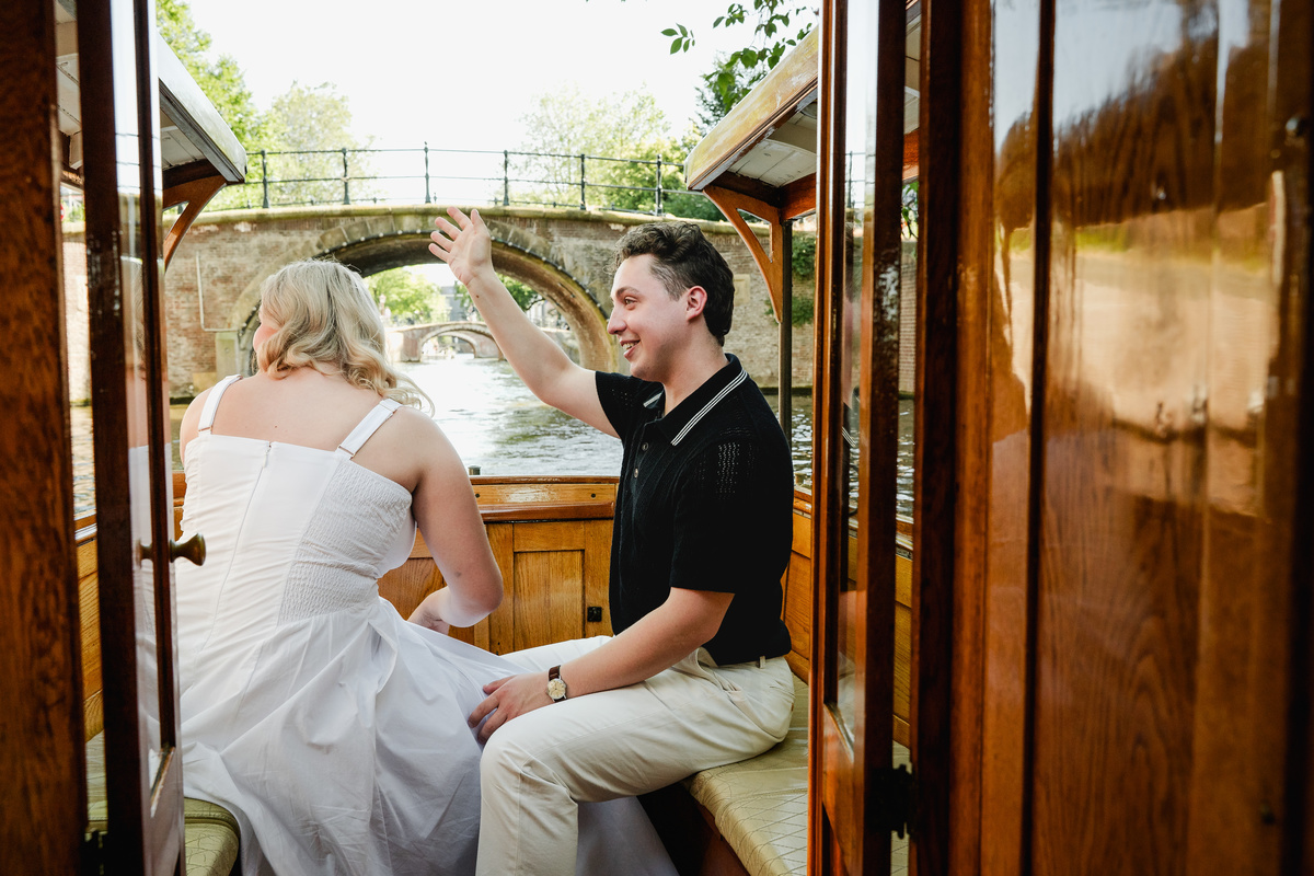 Newly engaged couple embracing beneath Amsterdam’s Seven Bridges