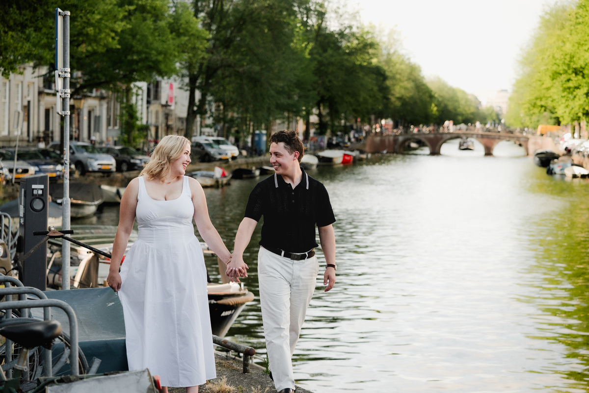 Couple walking near Leidsegracht after their boat proposal