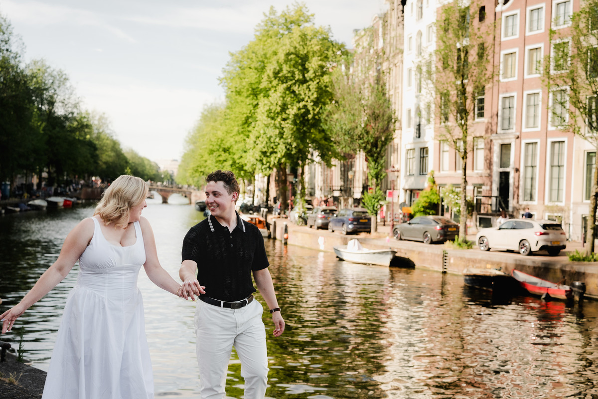 Couple walking near Leidsegracht after their boat proposal
