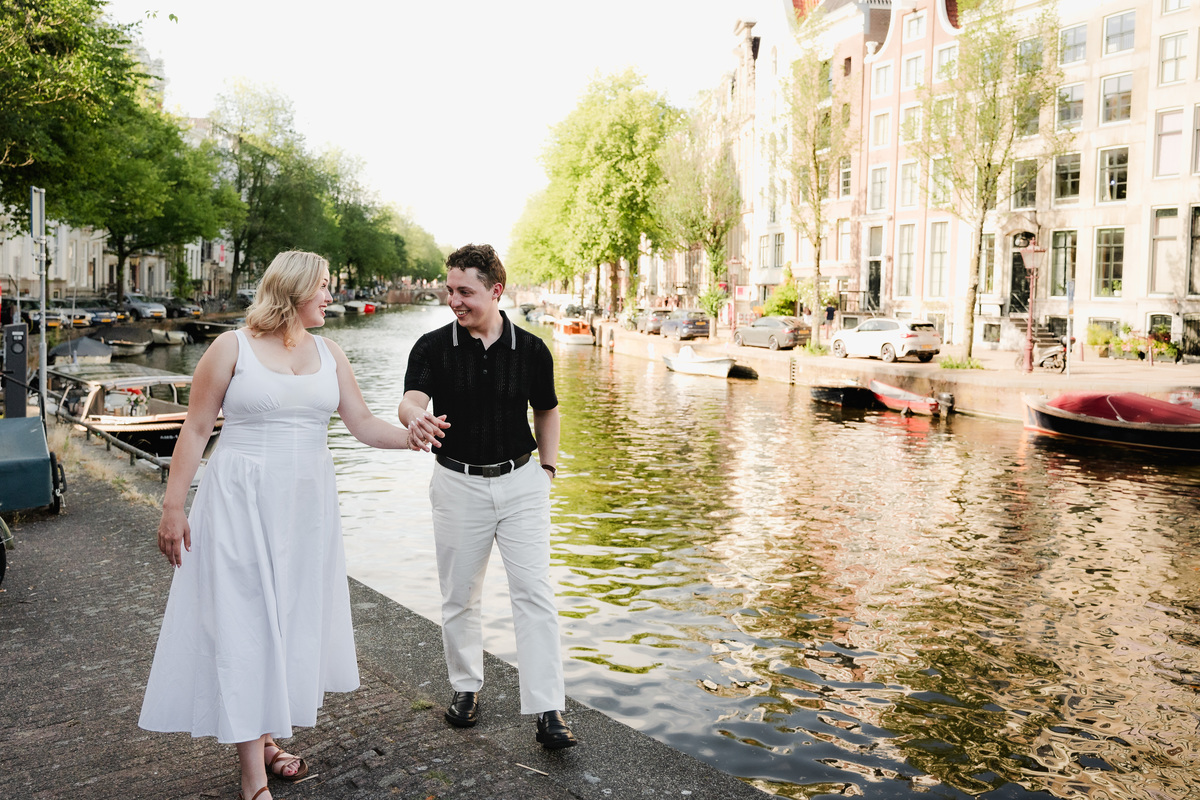 Couple walking near Leidsegracht after their boat proposal