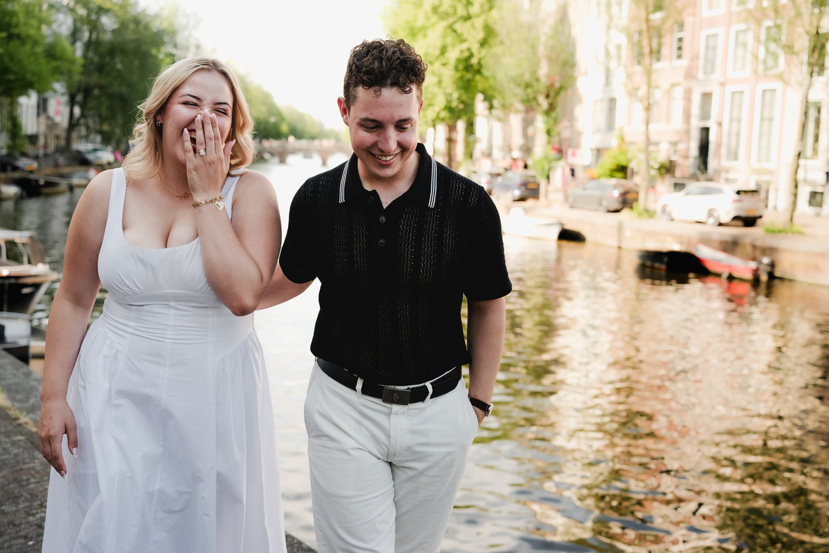 Couple walking near Leidsegracht after their boat proposal