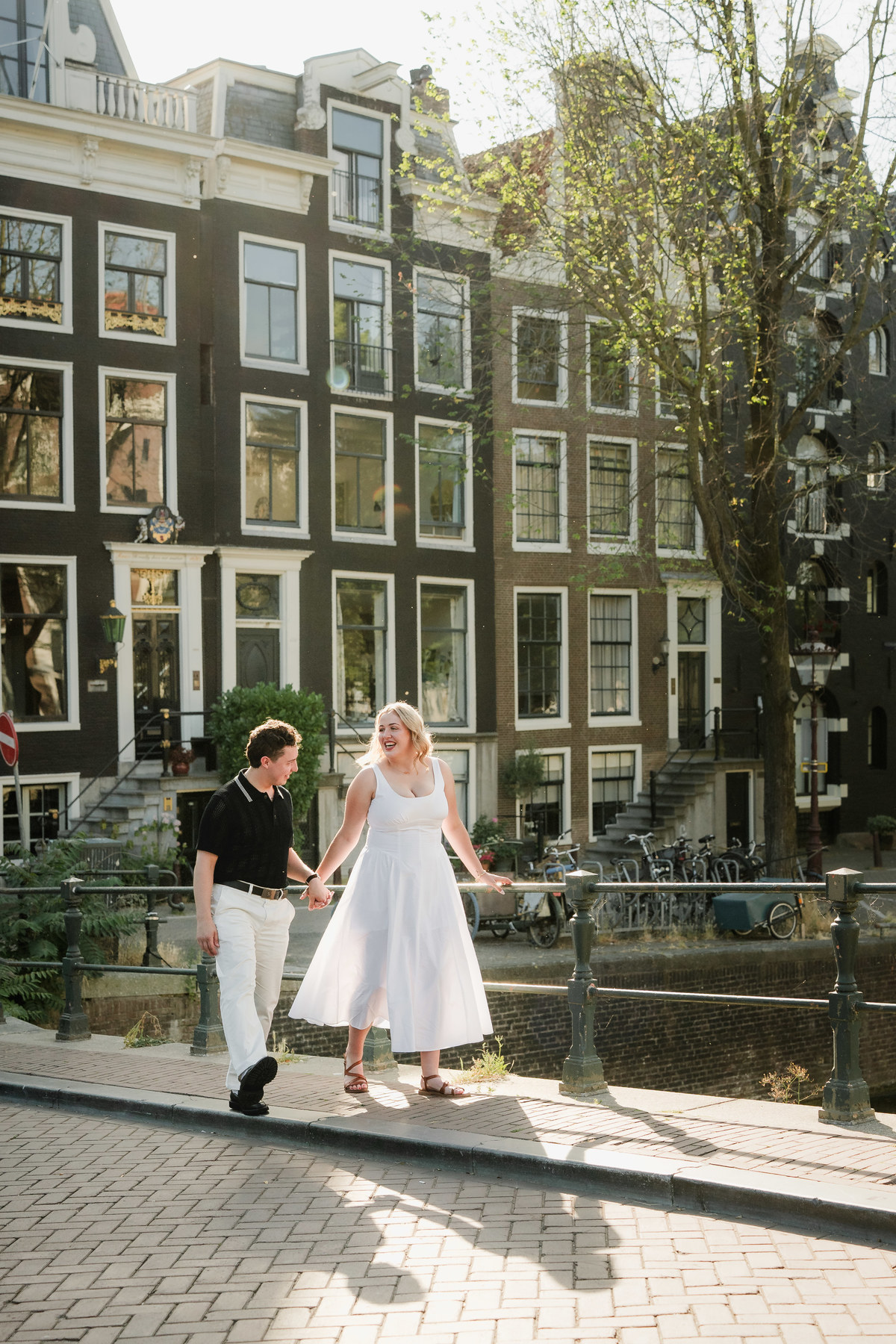 Couple walking near Leidsegracht after their boat proposal