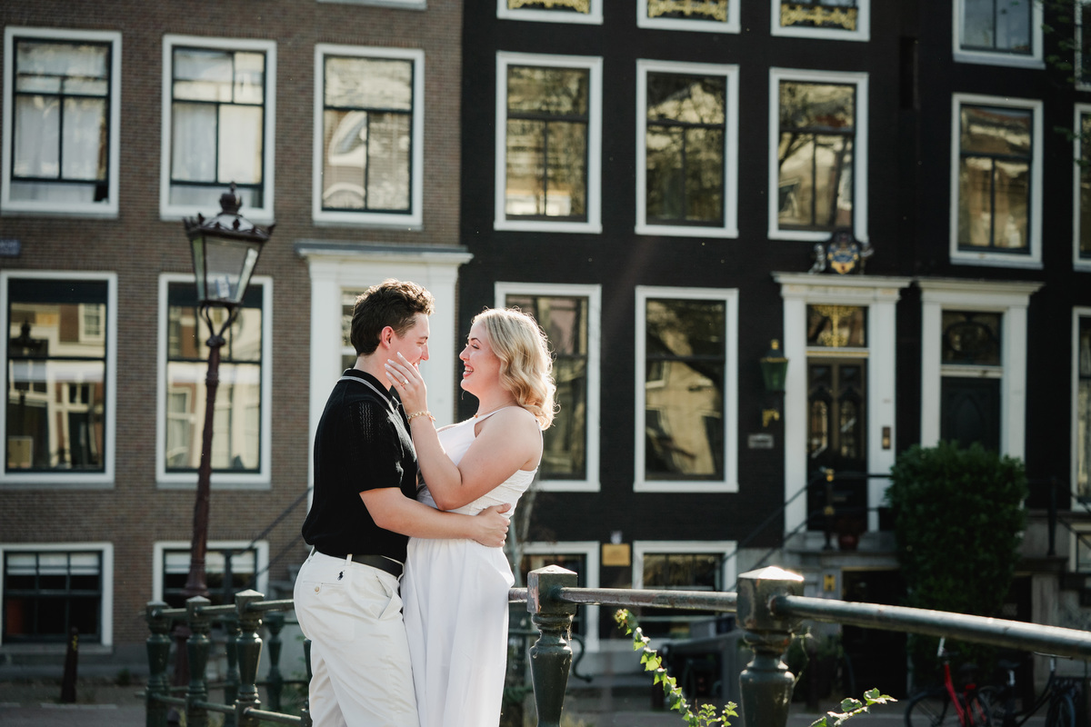 Natural engagement portrait beside an Amsterdam bridge