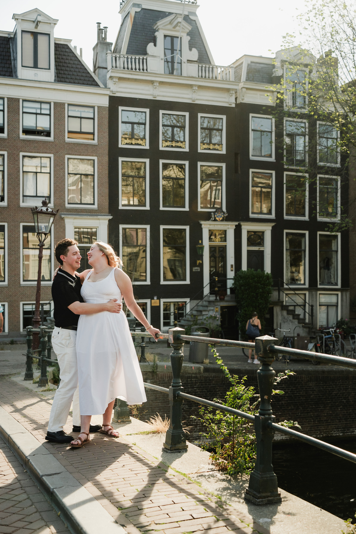 Natural engagement portrait beside an Amsterdam bridge