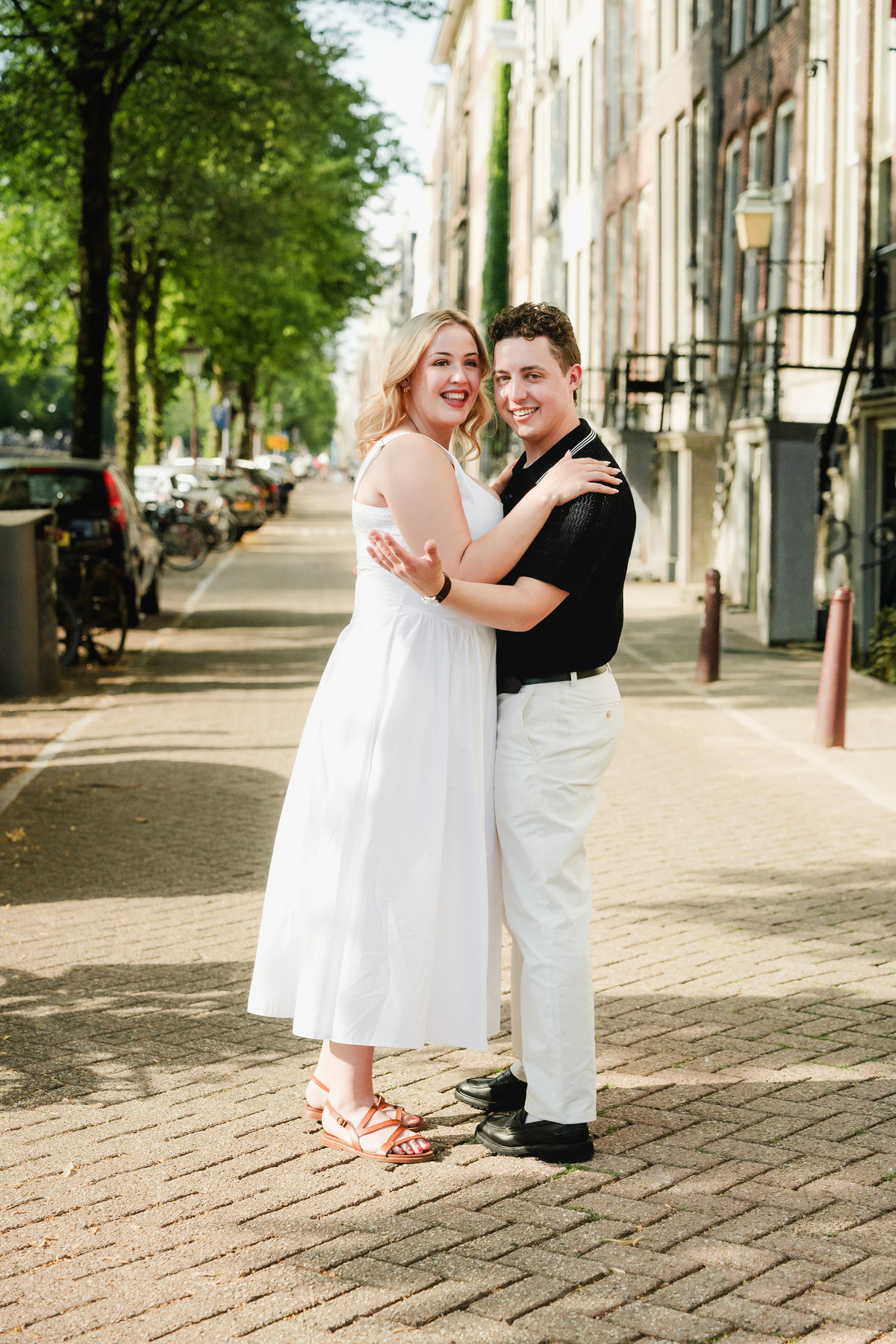 Natural engagement portrait beside an Amsterdam bridge
