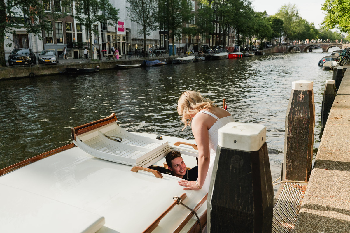 Couple boarding a historic wooden boat for a private Amsterdam canal cruise