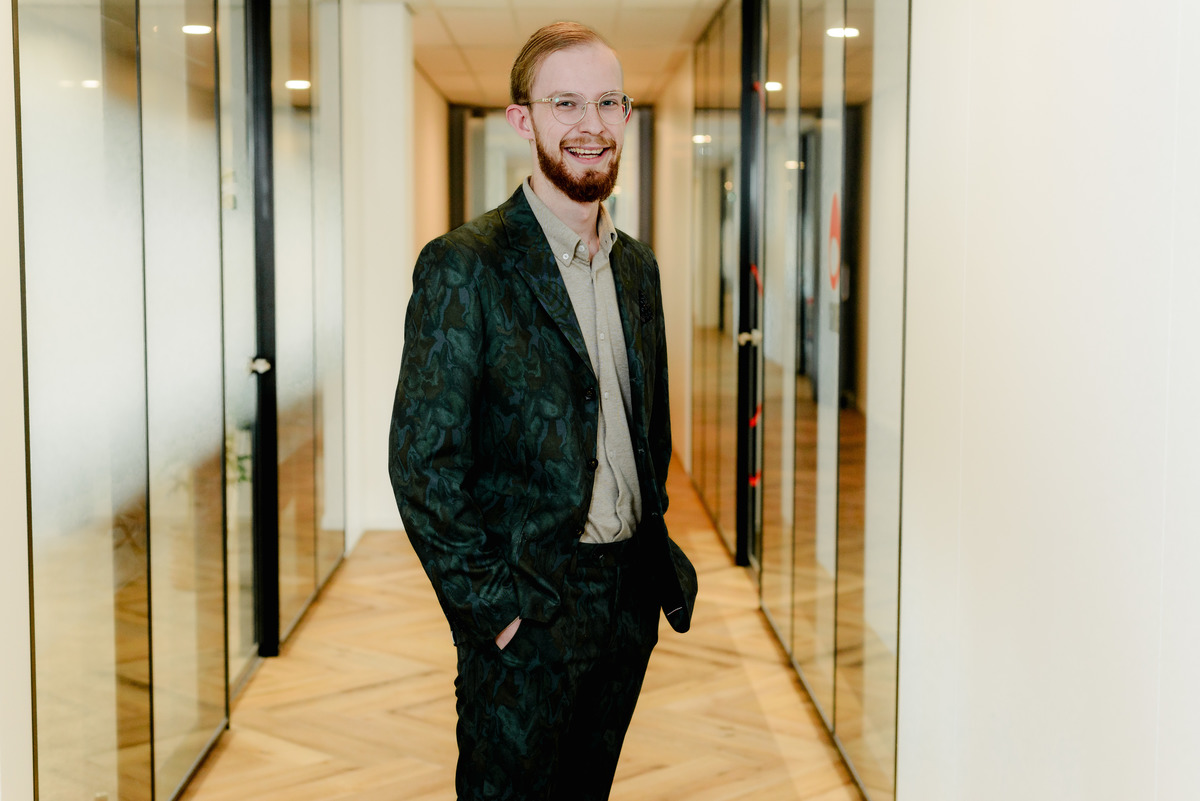 Individual business portrait of a professional standing inside an Amsterdam office