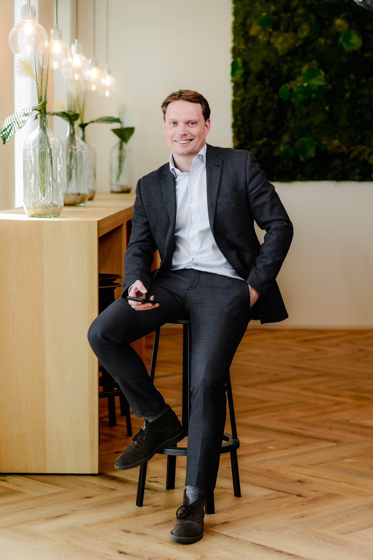Full-length seated business portrait for a company website and professional profile
