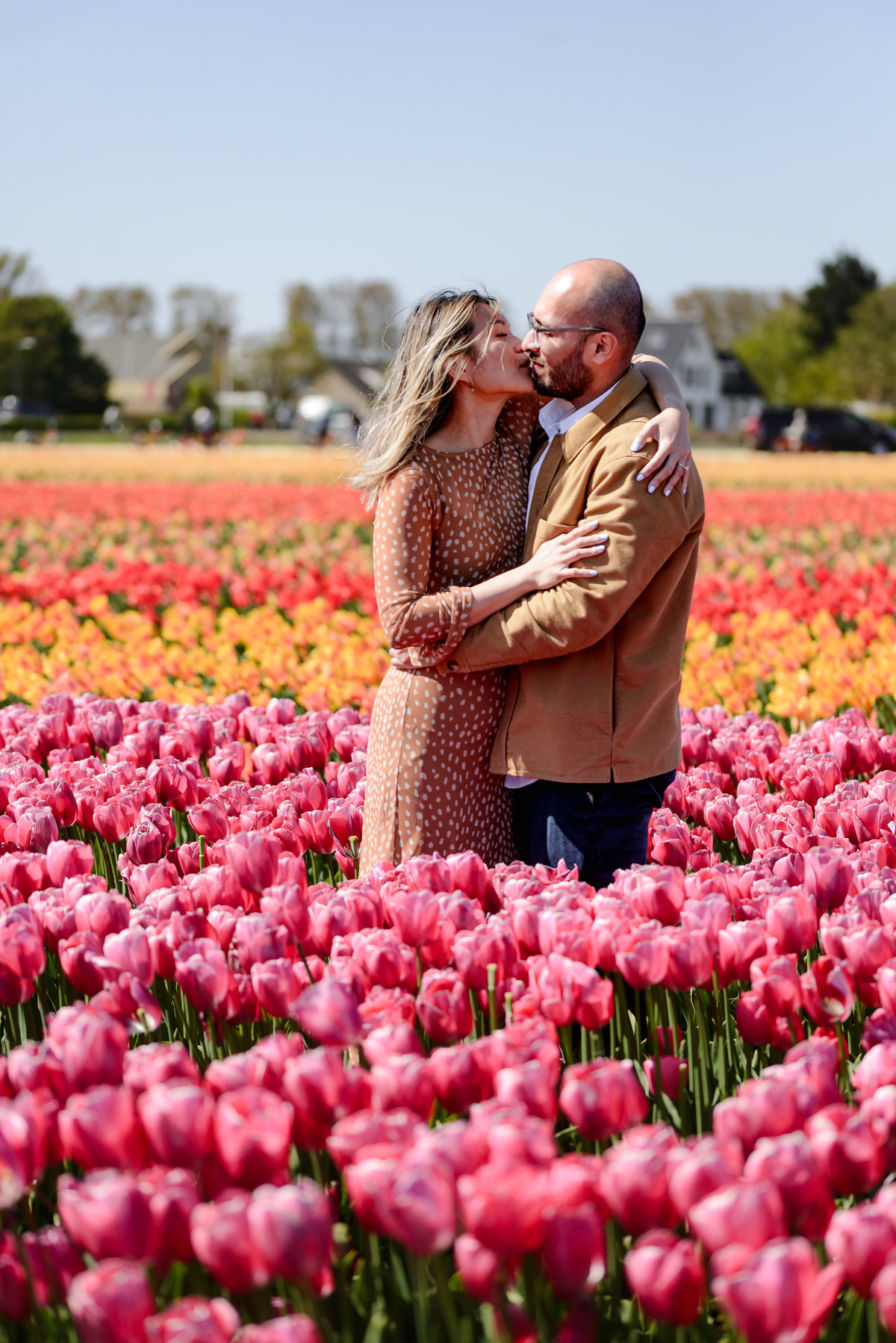 Newly engaged couple celebrating among tulips in the Netherlands