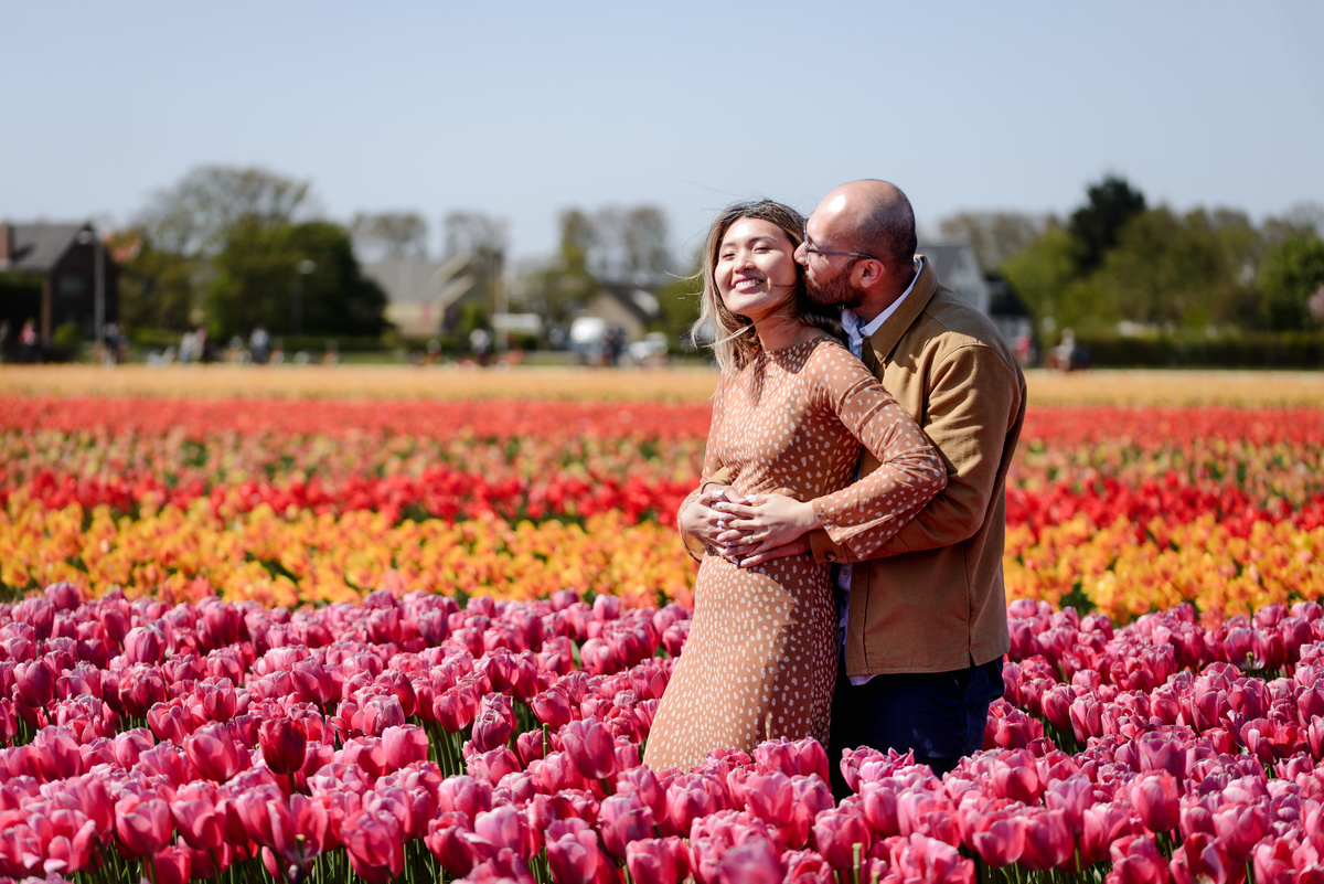 Newly engaged couple celebrating among tulips in the Netherlands