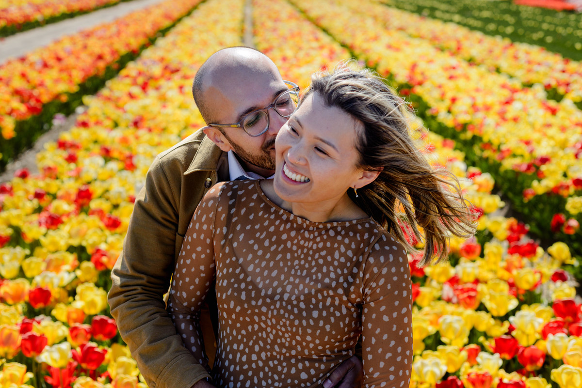 Couple laughing together after their surprise tulip proposal