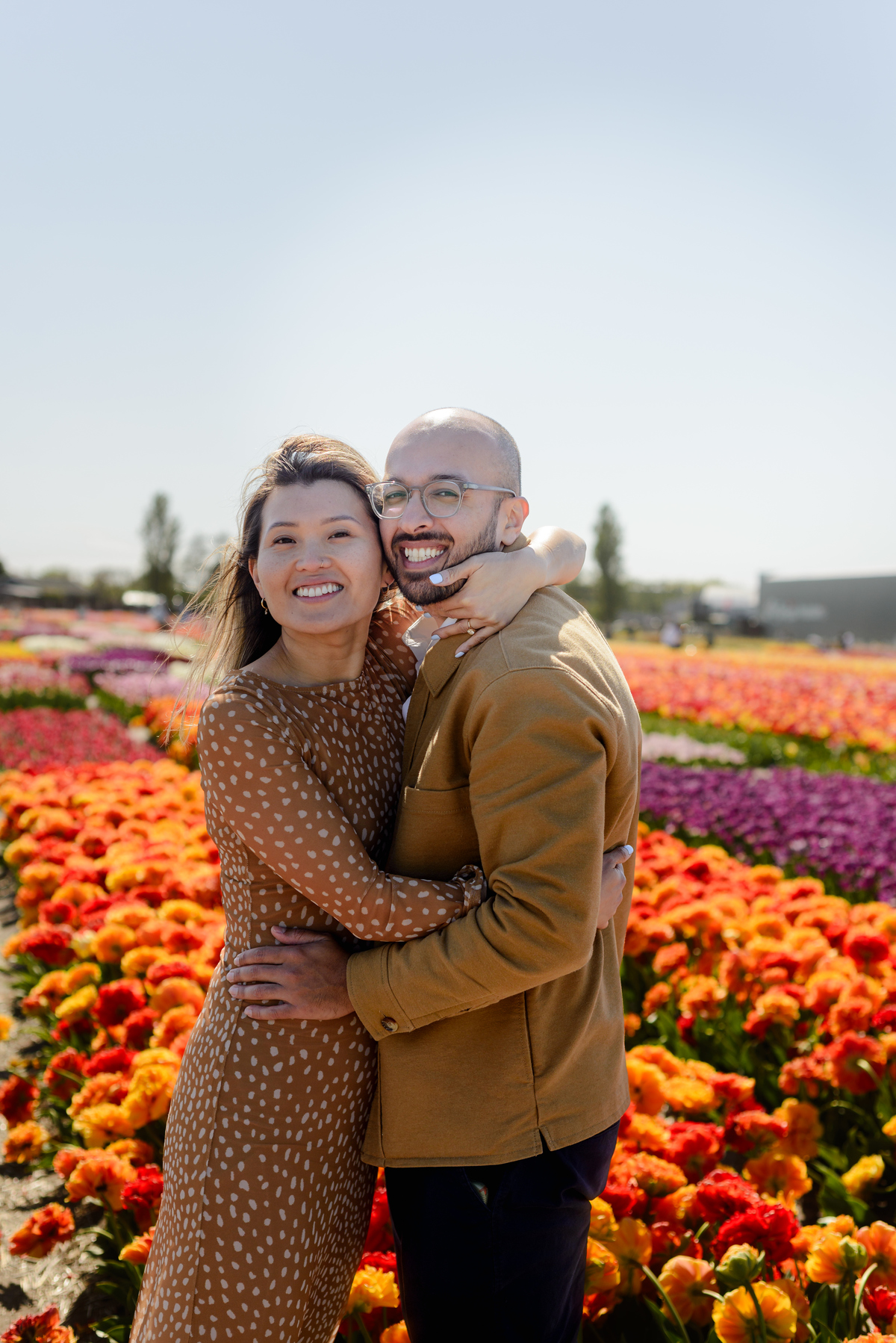Couple laughing together after their surprise tulip proposal
