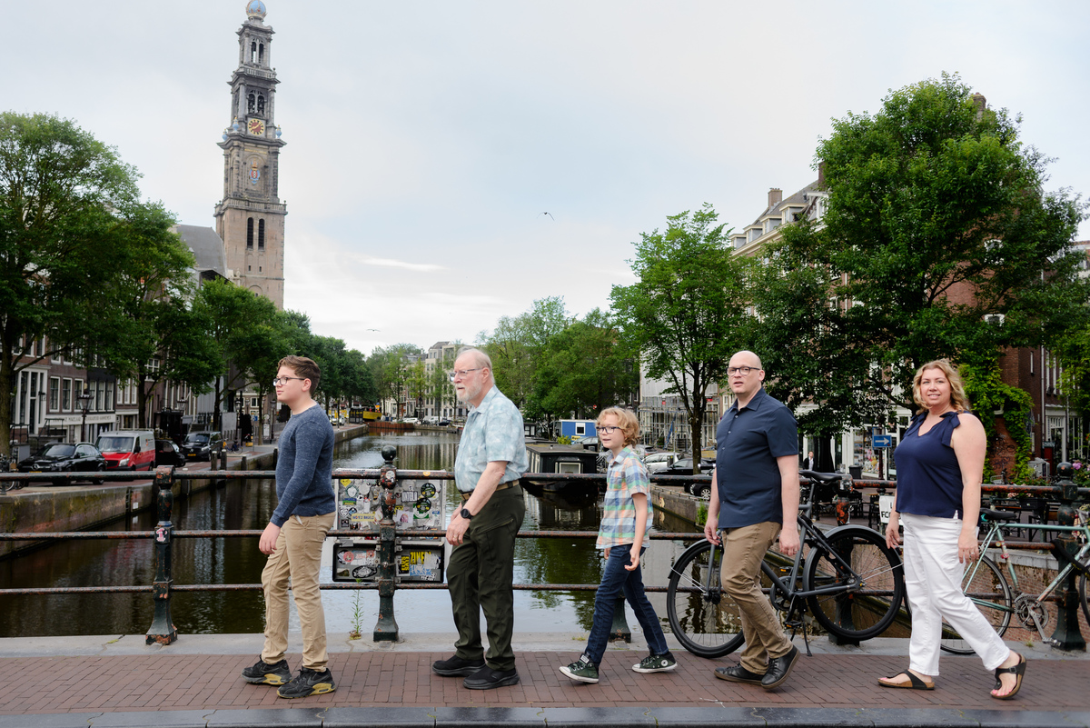 Family of four walking together beside the canals in Amsterdam