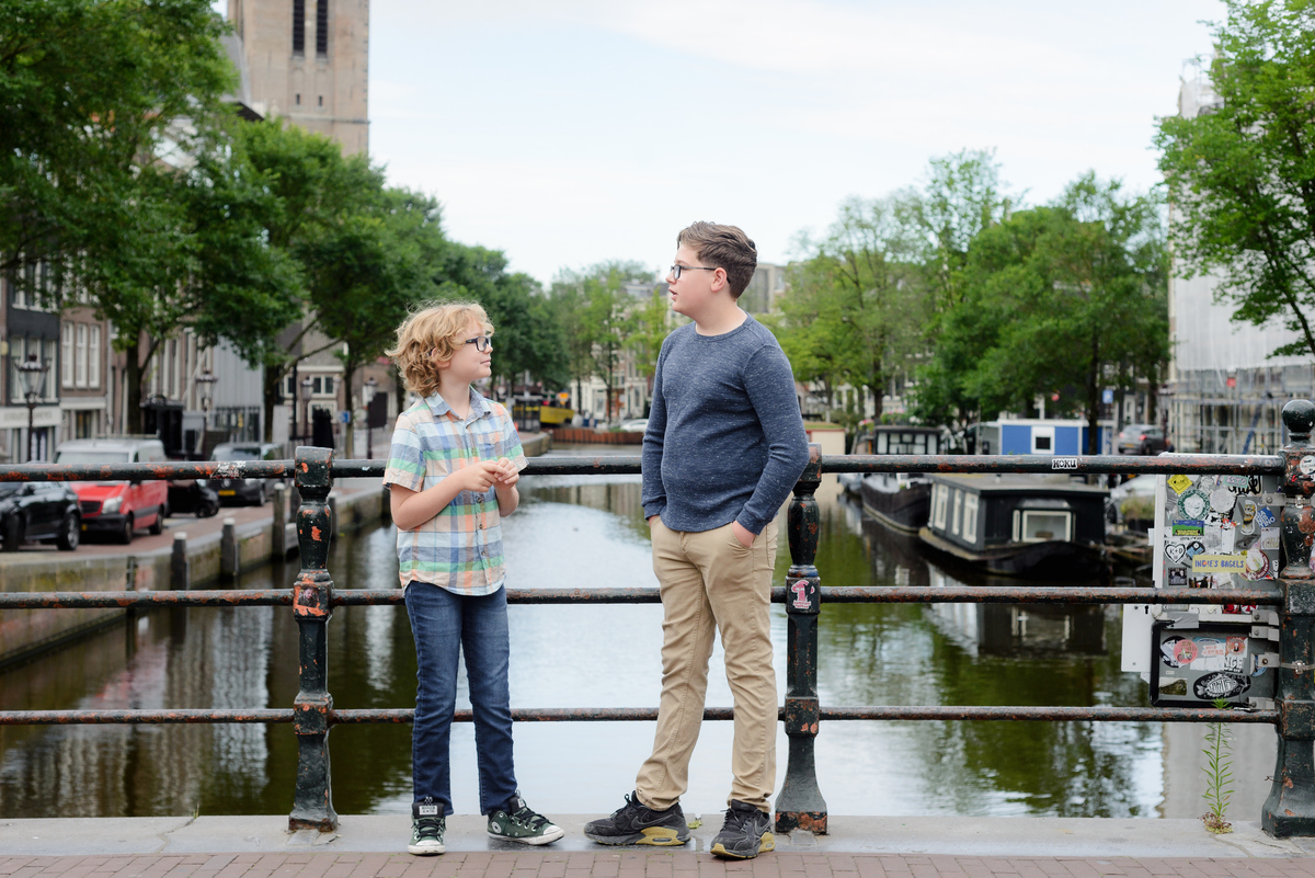 Kids photograph talking during a photo session with a canal view in the background. 