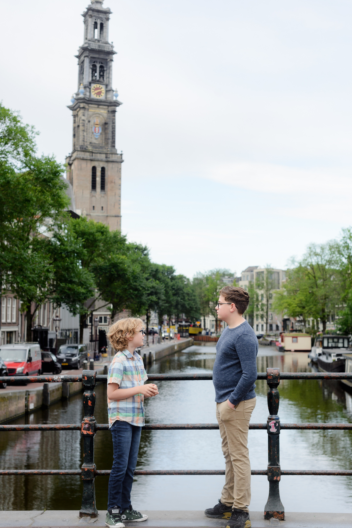 Kids photograph talking during a photo session with a canal view in the background. 