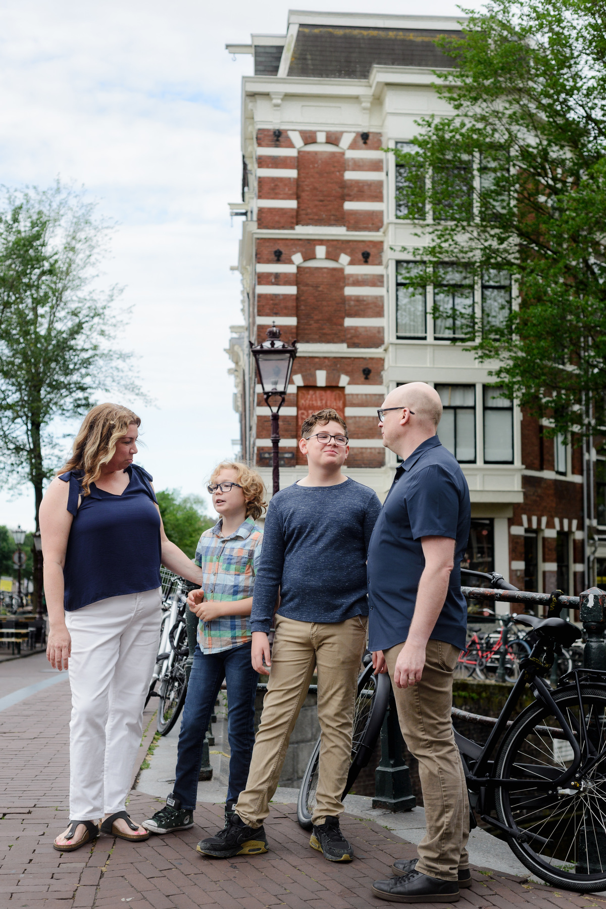 Family of four walking together beside the canals in Amsterdam