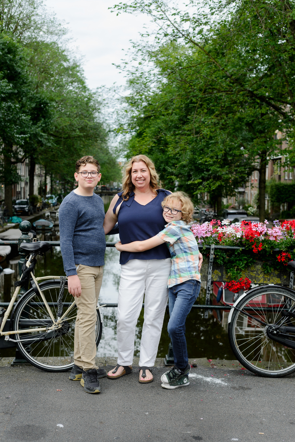 Mother talking with her sons on an Amsterdam canal bridge