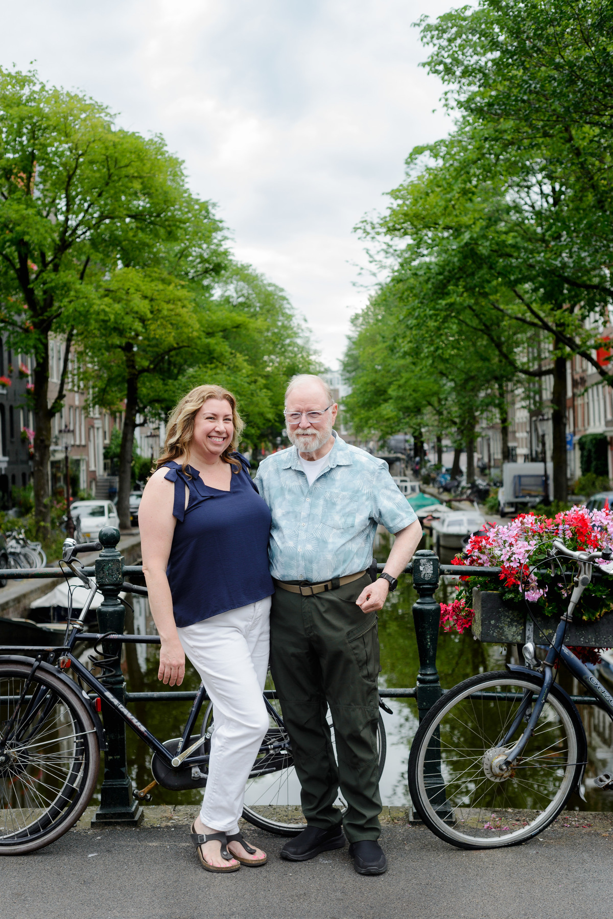 A father and adult daughter are looking at the camera during a photo session in the Jordaan area in Amsterdam. 