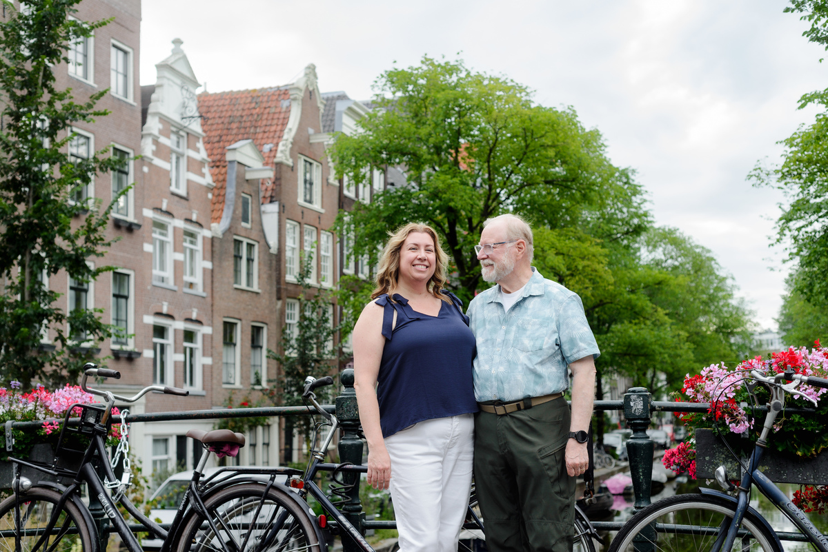 A father and adult daughter are looking at the camera during a photo session in the Jordaan area in Amsterdam. 