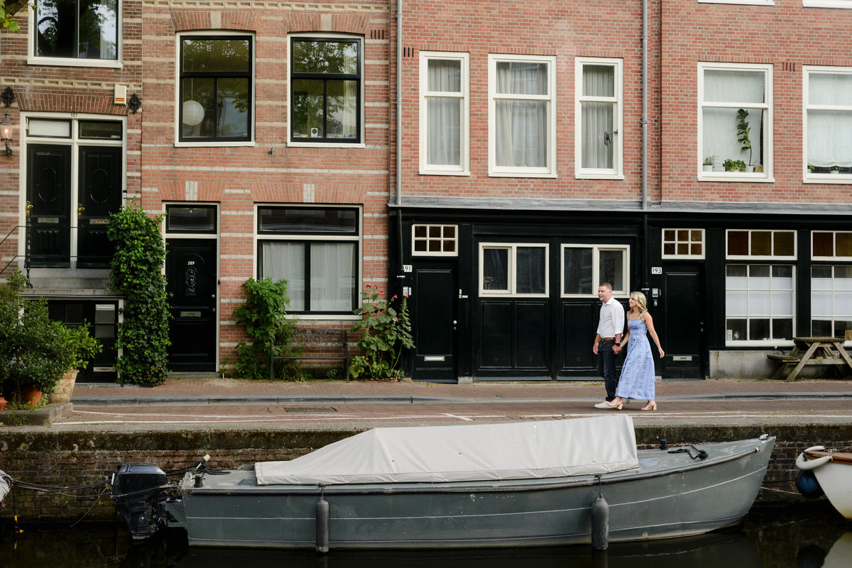 Couple walking together beside a quiet Amsterdam canal