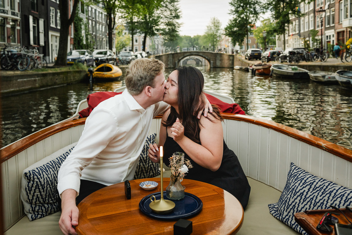 Newly engaged couple celebrating aboard an Amsterdam canal boat