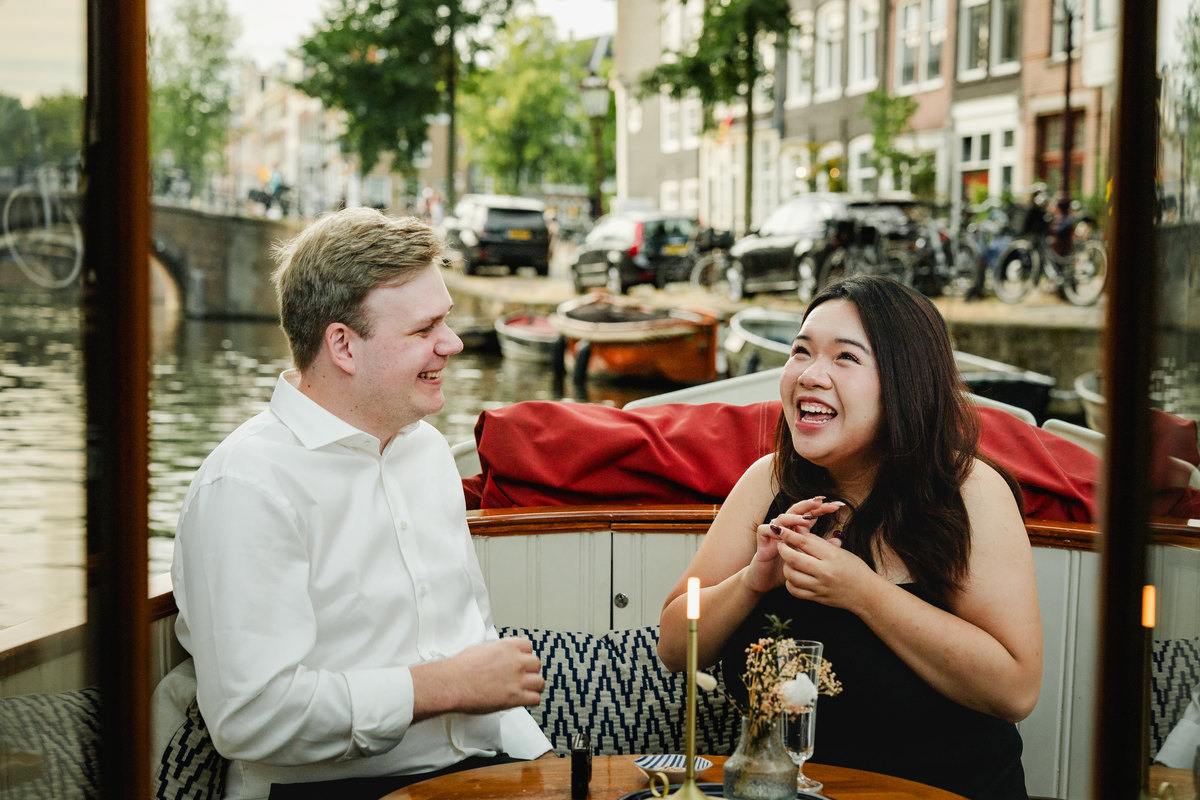 Newly engaged couple celebrating aboard an Amsterdam canal boat
