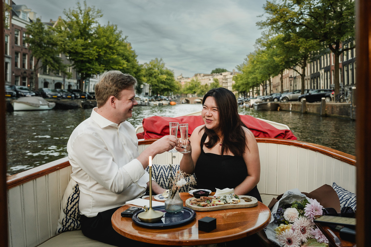 Newly engaged couple sharing an alcohol-free toast on the boat