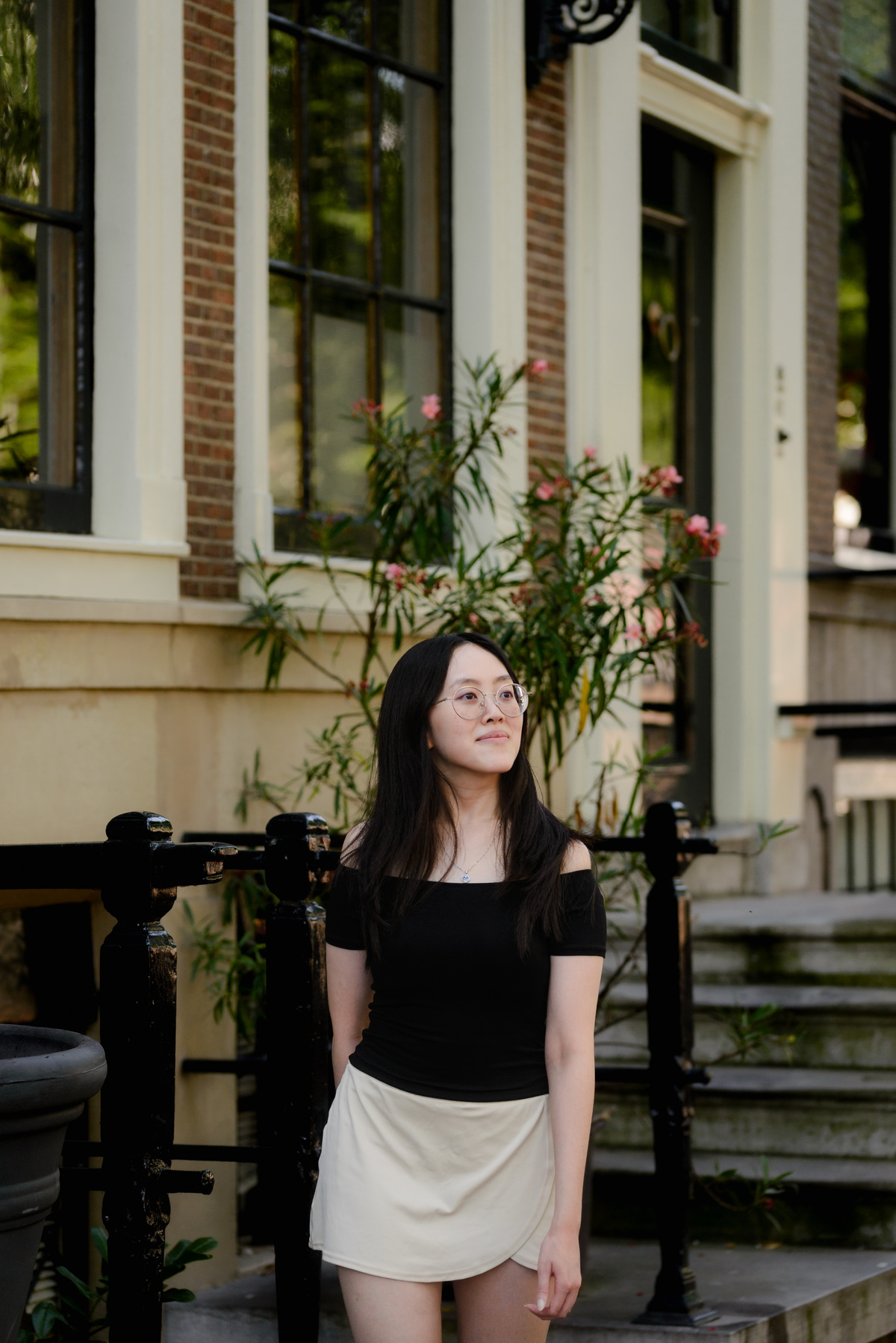 Solo traveller observing historic canal houses along Leidsegracht in Amsterdam